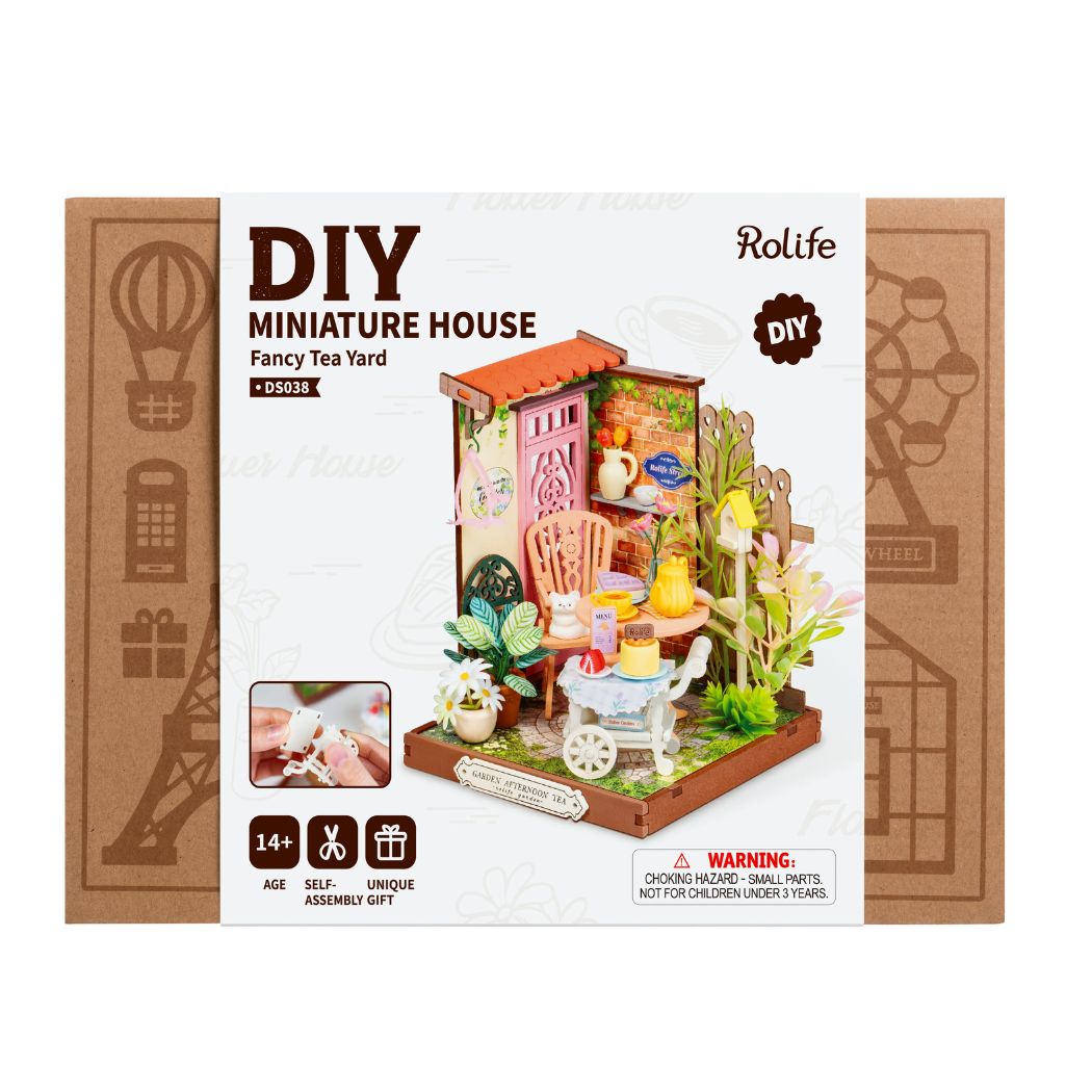 Puzzle in 3d che riproduce in miniatura una scena di un tea all'aperto.