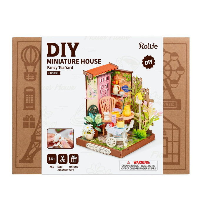 Puzzle in 3d che riproduce in miniatura una scena di un tea all'aperto.