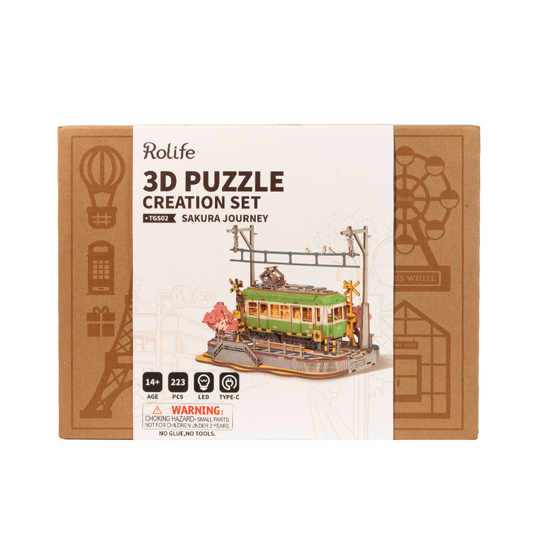 Puzzle in 3d che riproduce la stazione di un tram vicino ad un albero di ciliegio in fiore.